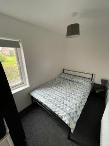 a bedroom with a bed in a room with a window at Modern 4 Bed Home, Free Parking in Hartlepool town in Hartlepool +27 photos