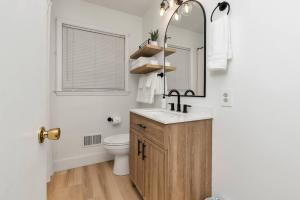a bathroom with a sink and a toilet and a mirror at Cozy modern duplex 5 min to downtown Spartanburg in Spartanburg +26 photos