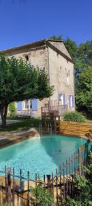 a small swimming pool in front of a building at Le Mas in Entrechaux