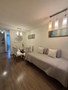 a bedroom with a bed and a table and chairs at Catedral Centro in Santiago