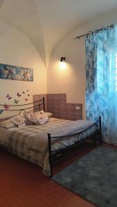 a bedroom with a large bed with blue curtains at La Sosta in Bagnoregio