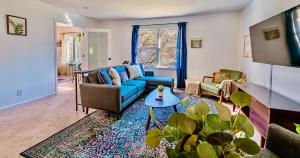 a living room with a blue couch and a table at 17 Min to NRG | Grill | Huge Yard | Private | Cozy in Oak Hill