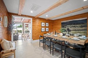 a dining room with a long table and chairs at 10min to NRG | Hot tub | Sauna | Firepit | 4br 3ba in Oak Hill