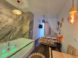 a bathroom with a large tub in a room at WARSZAWA CHMIELNA PRESTIGE HOME SPA APARTMENTS with Jacuzzi in the Heart of the City in Warsaw +101 photos