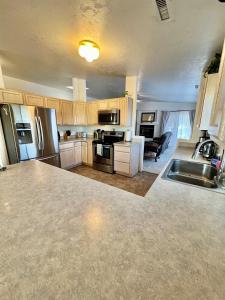 a kitchen with stainless steel appliances and a living room at Large Prescott Home with 3-car Garage Central & Quiet in Prescott