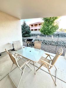 a glass table and chairs on a patio at Large Prescott Home with 3-car Garage Central & Quiet in Prescott