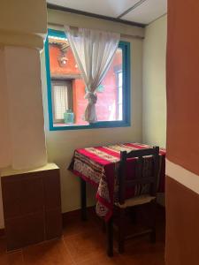 a small room with a table and a window at Casa los Molles Hostel in Maimará +68 photos
