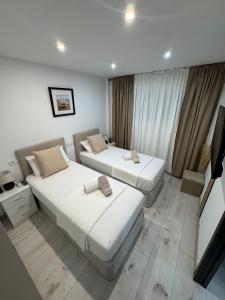 a bedroom with two beds and a window at Apartamento de lujo N&C con terraza - Playa Arenal Bol in Calpe