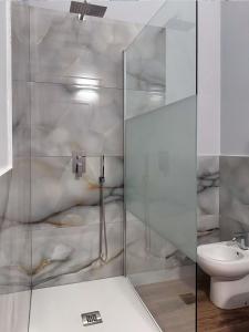 a bathroom with a shower with a toilet and a sink at Bed and Chic art rooms in Trieste