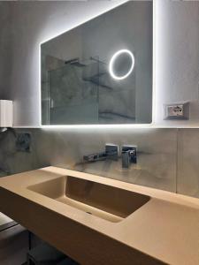 a kitchen with a sink and a mirror at Bed and Chic art rooms in Trieste +39 photos