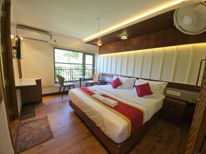 Un dormitorio con una cama grande con almohadas rojas. en Vistara Backwater Cruise, en Alleppey