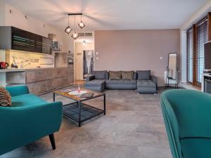 a living room with a couch and a table at SeaTowers 28 TOP FLOOR WATERFRONT PENTHOUSE! Sea & City PANORAMIC VIEW from GLASS CORNER TRIANGLE! 75m2! Terrace! Short&Long Stay! Parking! in Gdynia +163 photos