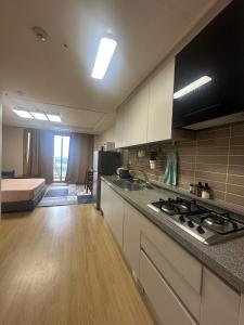 a kitchen with a stove and a bed in a room at Spacious Studio CondoinClark!FreeParking! in Fort Stotsenburg