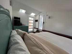 a white bed in a room with a window at Unique private room and bath in Halifax