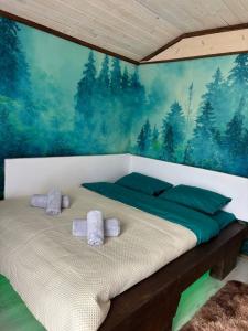 a bedroom with a bed with towels on it at Fox home in Khashchovanoye