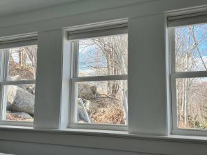 three windows in a room with trees in the background at Unique private room and bath in Halifax +8 photos