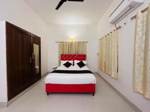 a bedroom with a red and white bed in it at Blue Shell in Chennai
