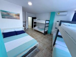 a bedroom with two bunk beds and a desk at Arenamar Hotel Rodadero in Rodadero +26 photos