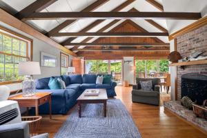 a living room with a blue couch and a fireplace at Great location with Water Views in Harwich