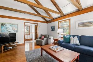 a living room with a blue couch and a table at Great location with Water Views in Harwich +24 photos