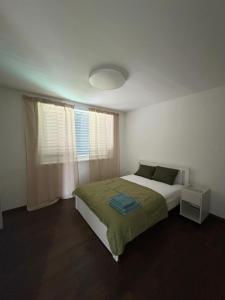 a white bedroom with a bed and a window at Exkluzívny rodinný dom Trnava - rodiny, pracovné cesty in Trnava +31 photos
