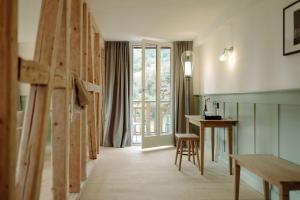 a room with a wooden staircase and a table at THE HUS am Weinberg in Flums +16 photos