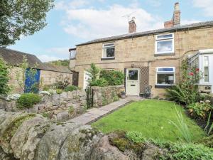 an exterior view of a brick house with a yard at 5 Belper Lane End in Belper