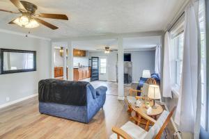 a living room with a blue couch and a table at 7 Mi to Barren River Lake Quiet Getaway with Yard! in Lucas