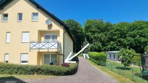 a house with a large clock on the side of it at OstSEESTERNchen Zempin in Zempin