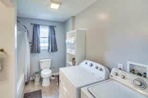 a laundry room with a washing machine and a toilet at 7 Mi to Barren River Lake Quiet Getaway with Yard! in Lucas +24 photos