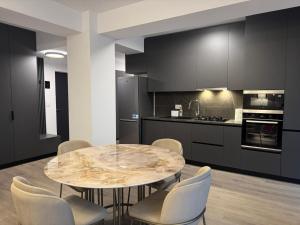 a kitchen with a round table and chairs in it at Daiana Apartament in Timişoara