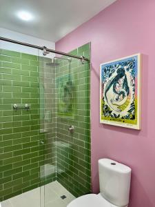 a bathroom with a toilet and a glass shower at Vecinos by La Palmera in Bogotá +52 photos