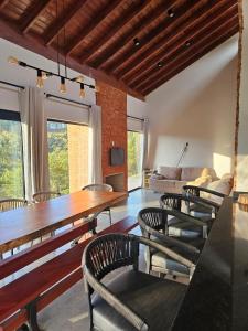 a dining room with a wooden table and chairs at Casa em Chácara com Cacheira in Muzambinho