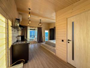 a kitchen and living room of a house at AFTERGLOW verkhovyna in Iltsi