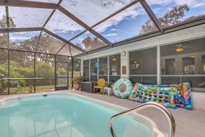 a swimming pool in a house with a conservatory at Dog-Friendly Home, Lake Henderson Across Street! in Inverness