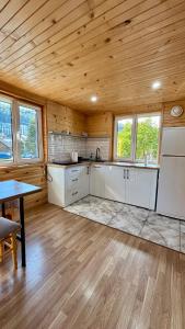 a kitchen with white cabinets and a wooden ceiling at DubOk in Yaremche