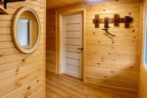 a wooden room with a mirror and a door at DubOk in Yaremche +6 photos