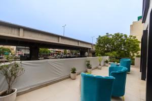 a row of blue chairs on the roof of a building at Hotel Lexus in New Delhi