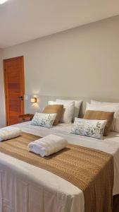 2 große weiße Betten nebeneinander in der Unterkunft Casa Morada do Lago in Santa Maria + 82 Fotos