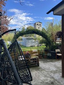 a garden with an arch with a table and chairs at Guest Hause Lile in Tsʼageri +10 photos