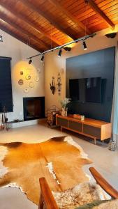 ein großes Wohnzimmer mit einem großen Flachbild-TV in der Unterkunft Casa Morada do Lago in Santa Maria