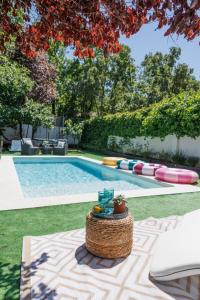 a swimming pool with a rattan table next to a swimming pool at Chalet de 6 habitaciones en la Sierra de Madrid El Olivo de Miraflores in Miraflores de la Sierra