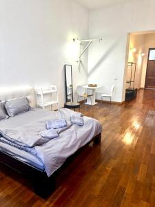 a bedroom with a bed with a table and chairs at Central Studio With Parking in Arad
