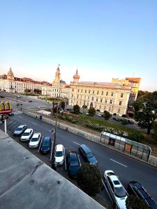 a row of cars parked in a parking lot in front of a building at Central Studio With Parking in Arad