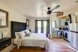 a bedroom with a bed and a kitchen at Close to Hospitals Peaceful Birmingham Studio in Wisteria Commons