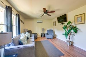 a living room with a couch and a ceiling fan at 9 Mi to UAB Tranquil Remote-Work Escape! in Wisteria Commons