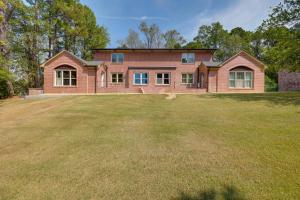 a large brick house with a large yard at 6 Mi to the Summit Stylish Apt with Patio Access in Wisteria Commons