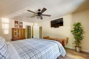 a bedroom with a ceiling fan and a bed at 6 Mi to the Summit Stylish Apt with Patio Access in Wisteria Commons