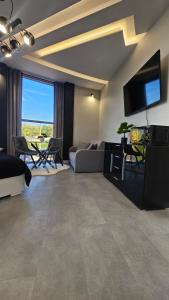 a living room with a couch and a flat screen tv at Anpol 4 in Inowrocław