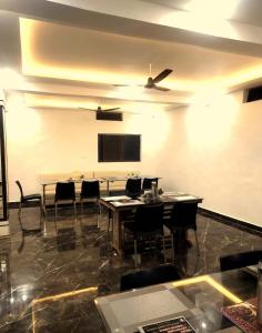 a dining room with tables and chairs and a flat screen tv at Shree Siddhi Vinayak Hotel & Restaurant in Bargi